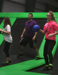 Team Playing Dodgeball on Trampolines